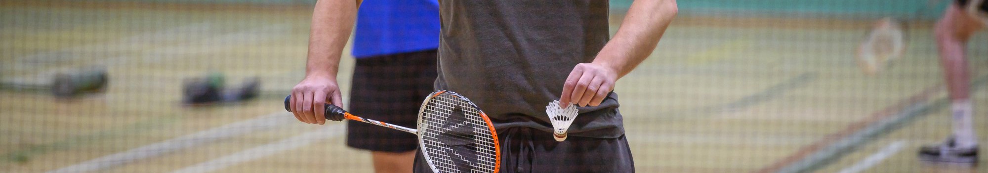 Two men playing badminton